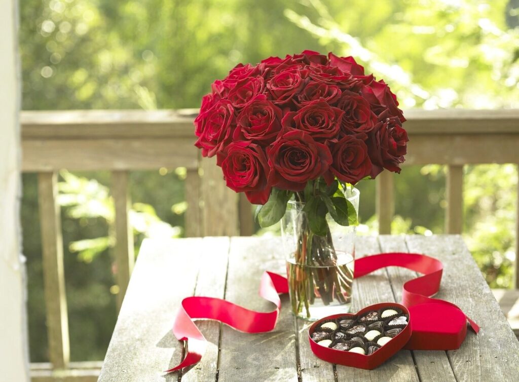 Romantic Red Roses Wallpaper: Elegant Bouquet on Rustic Table