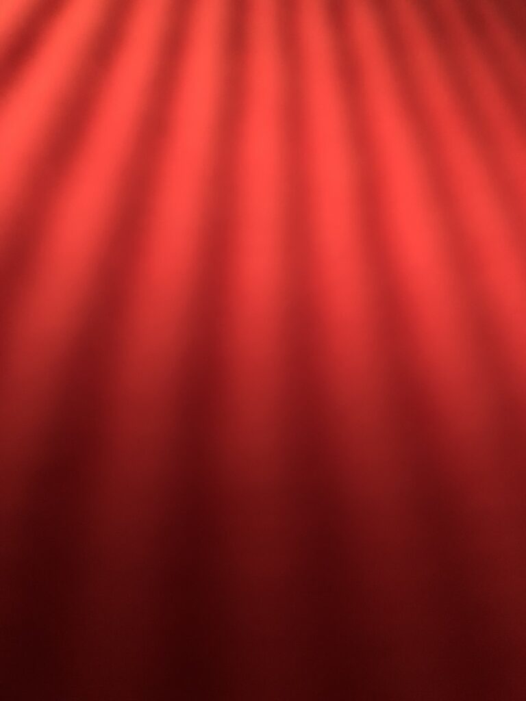 Dynamic Red Background Wallpaper with Light Rays and Texture