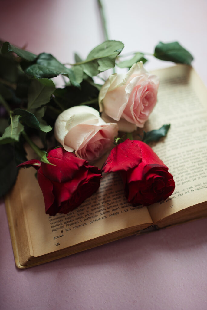 Elegant Red & White Roses Wallpaper on Open Book - Aesthetic Background