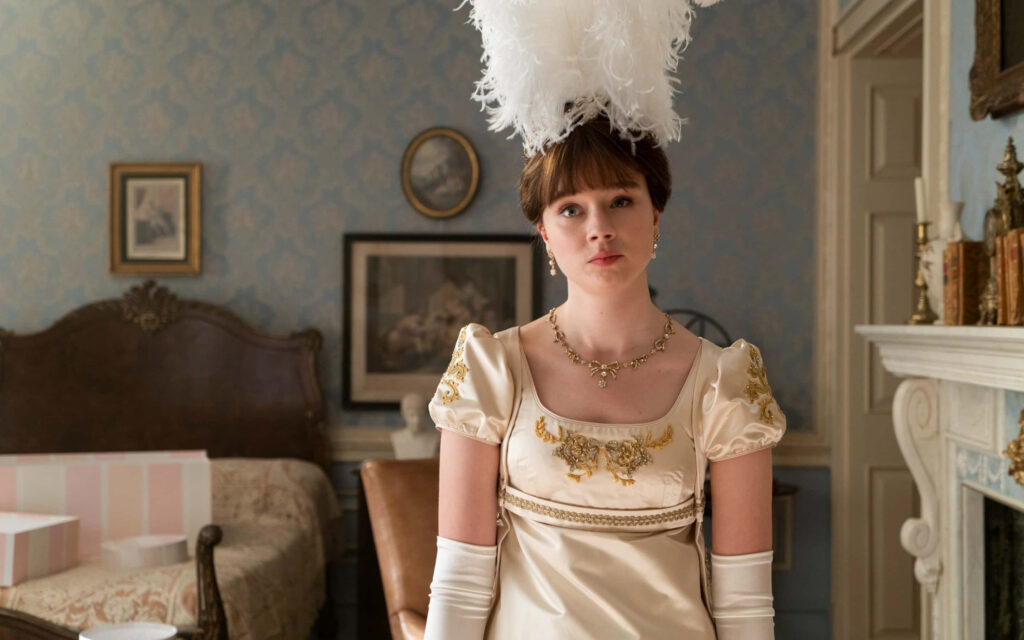Regency Elegance Wallpaper: Young Lady in Gold-Accented Attire