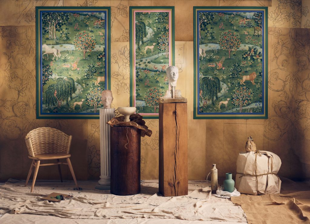 Rustic art studio with rose wallpaper rattan chair plaster busts medieval Millefleurs tapestries