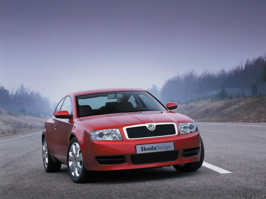 Elegant Skoda Superb Combi Wallpaper: Red Car on Misty Road