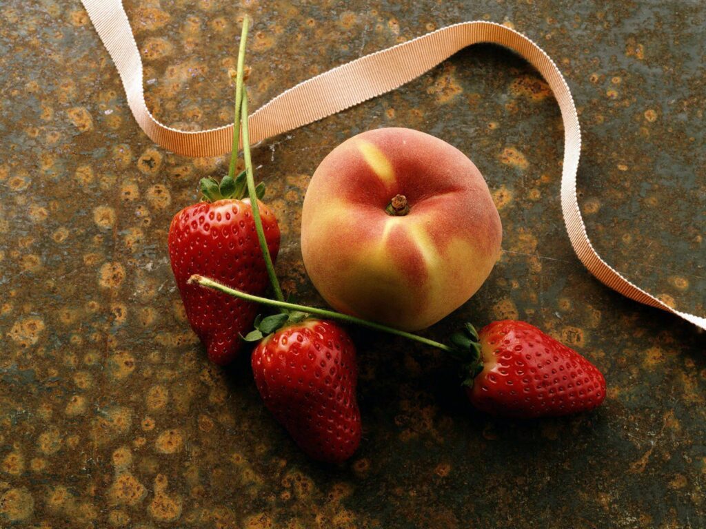 Elegant Strawberry Peach Wallpaper on Rustic Textured Surface