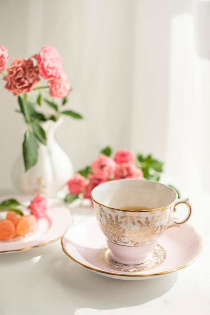 Elegant Tea Time Wallpaper: Teacup, Treats & Pink Flowers Design