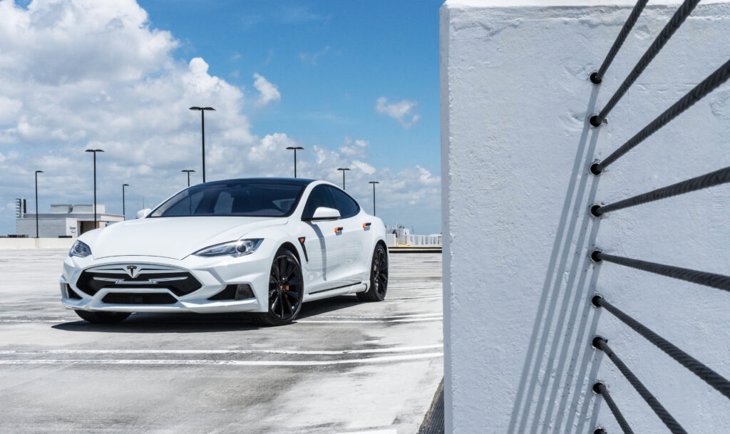Sleek White Tesla Model S on Rooftop: Luxury Electric Car Wallpaper