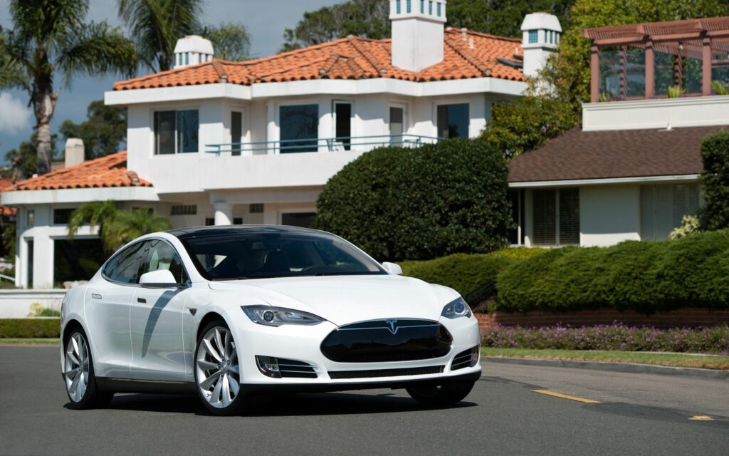 Sleek White Tesla Model S in Luxury Suburban Setting Wallpaper