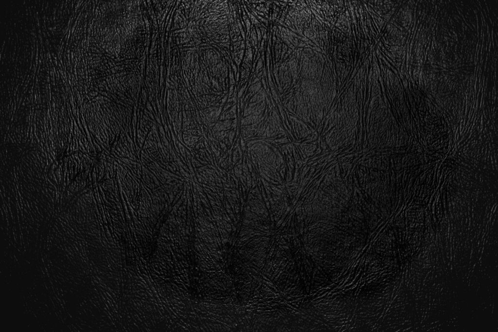 Elegant Textured Black Wallpaper with Intricate Leather Patterns