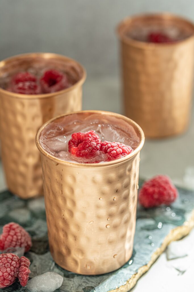 Elegant Raspberry Cocktail with Ice in Textured Glasses - Wallpaper