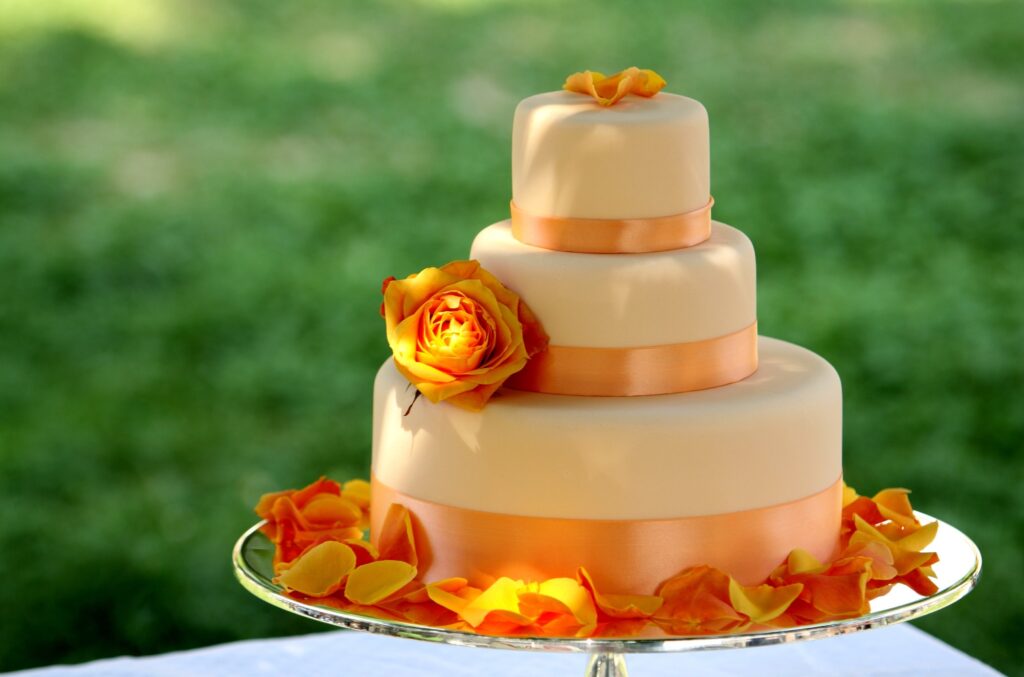 Stunning Three-Tier Cake Wallpaper with Orange Ribbons & Roses