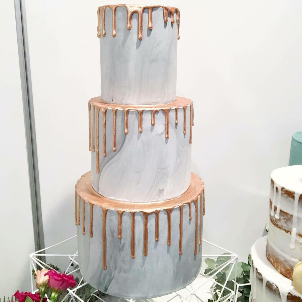 Three-tier marble cake wallpaper with rose gold drip and gray white tones for elegant decor