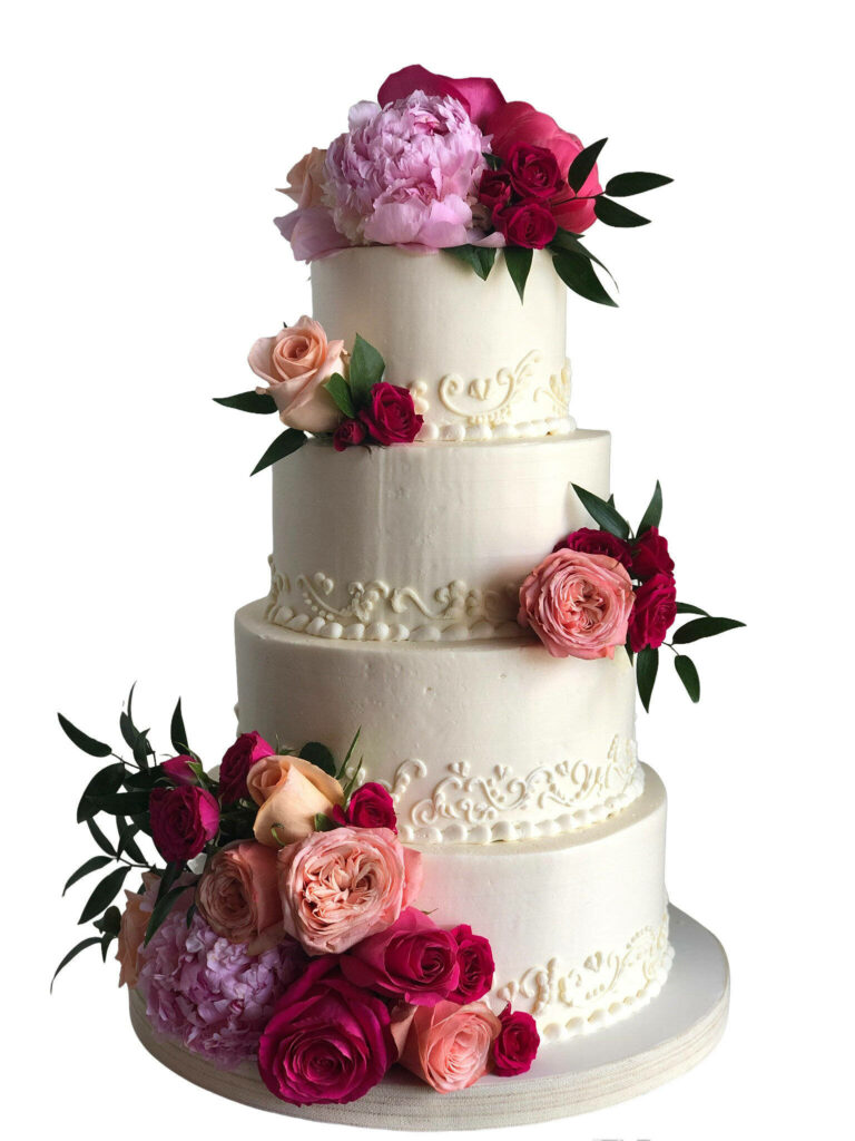 Elegant three-tiered wedding cake with white frosting and vibrant pink red purple rose bouquets Wallpaper