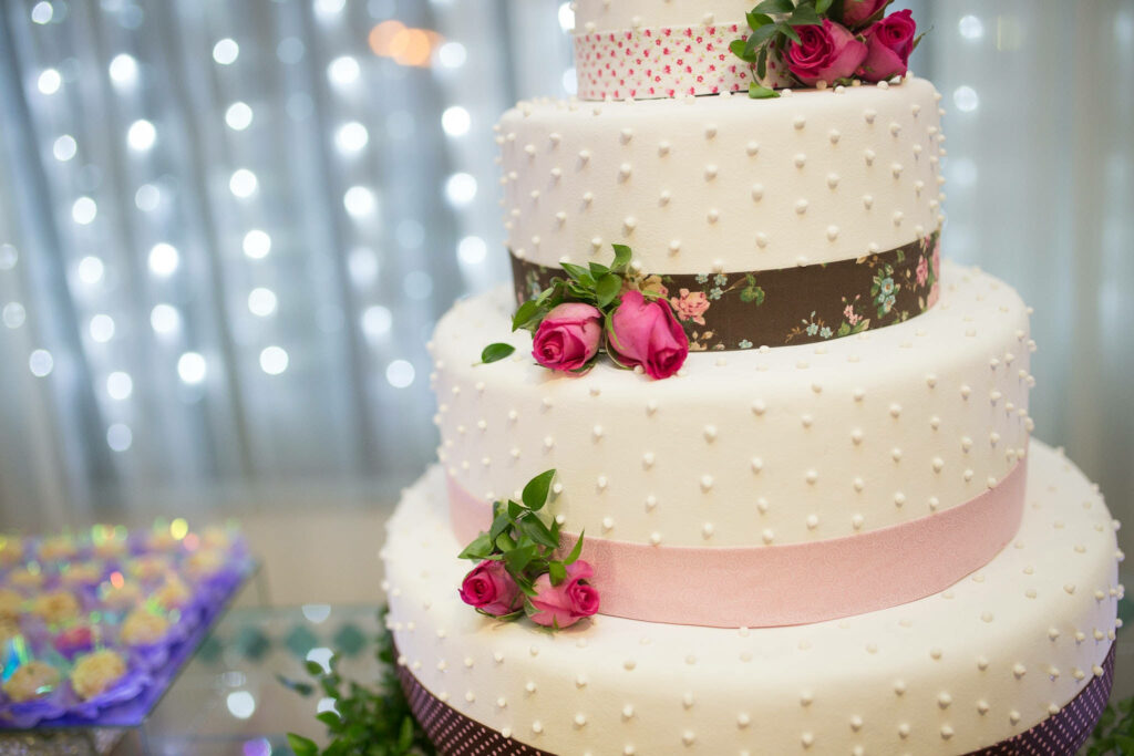 Elegant wedding cake wallpaper with pearls pink roses and pastel ribbons for celebration