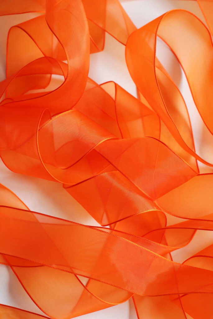 Elegant Translucent Orange Ribbon Wallpaper Background Design