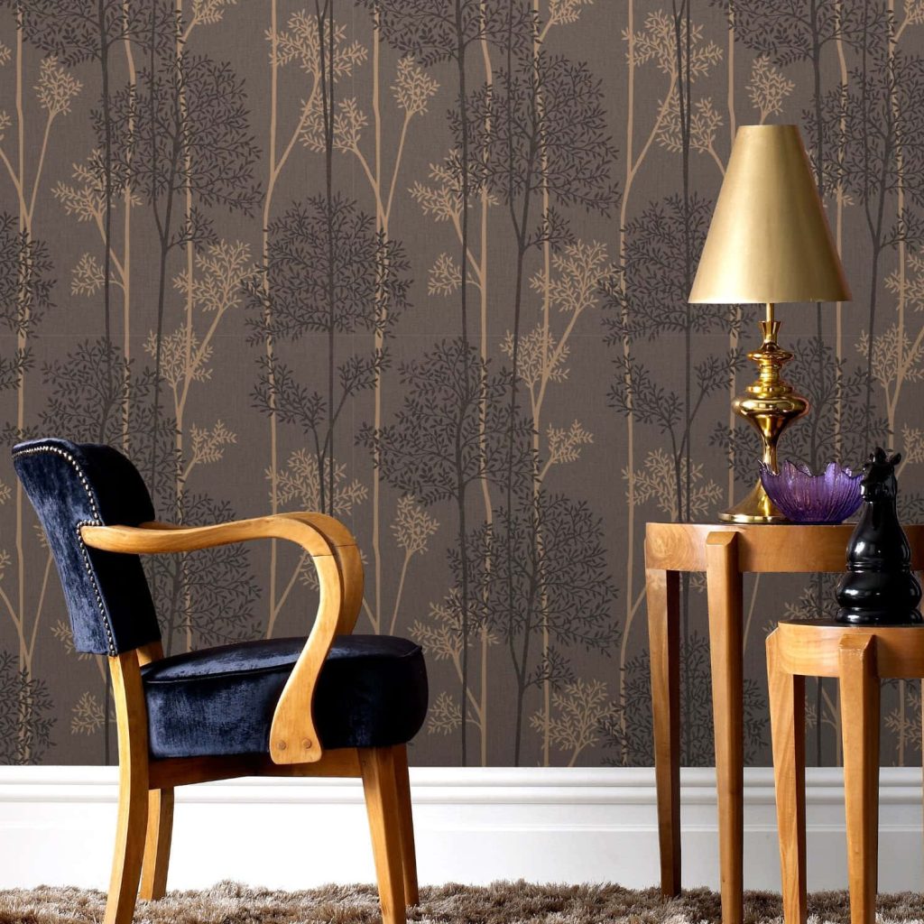 Elegant tree-patterned wallpaper with navy blue velvet chair wooden furniture and bronze lamp
