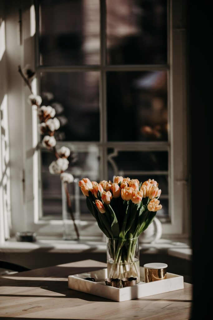 Elegant Tulip Bouquet in Glass Vase: Serene Window Background Wallpaper