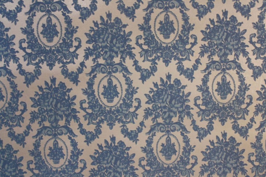 Elegant Victorian wallpaper with slate blue damask floral baskets on cream background