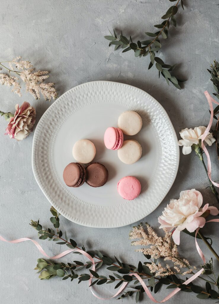 Elegant Dessert Wallpaper: Colorful Macarons & Floral Serenity