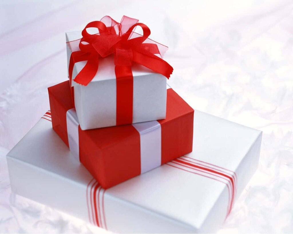 Stack of elegant white wedding gift boxes with red ribbons festive joyful celebration wallpaper