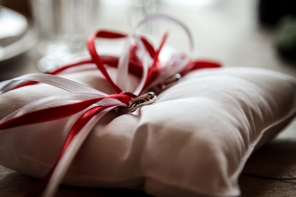 Elegant Wedding Rings on Plush Pillow - Romantic Wallpaper Background