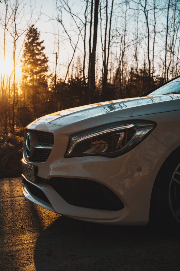 Sleek White Car Wallpaper: Elegant Design at Sunset in Forest Backdrop