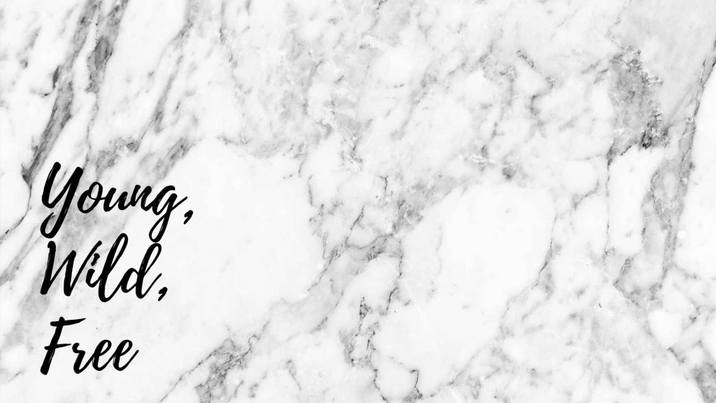 Elegant white marble wallpaper with black cursive Young Wild Free text and grey veins