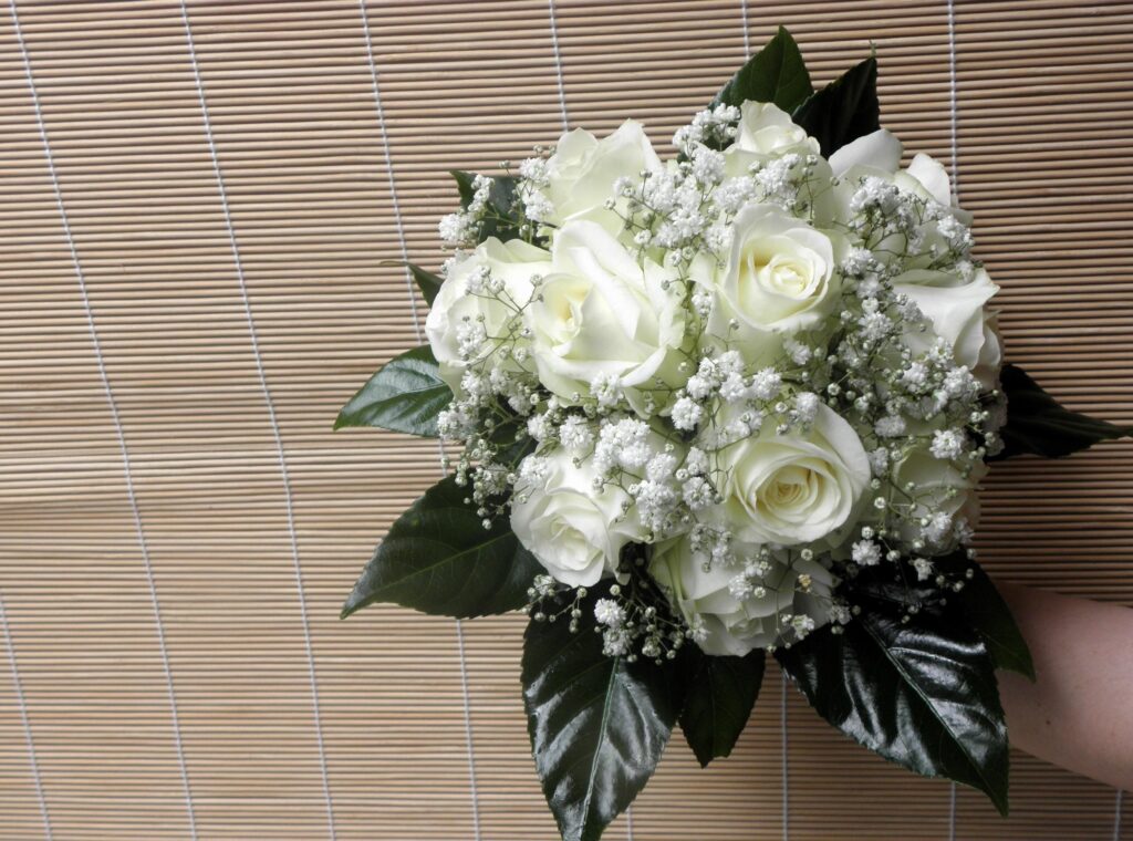 Elegant White Rose Bouquet with Gypsophila on Textured Background Wallpaper