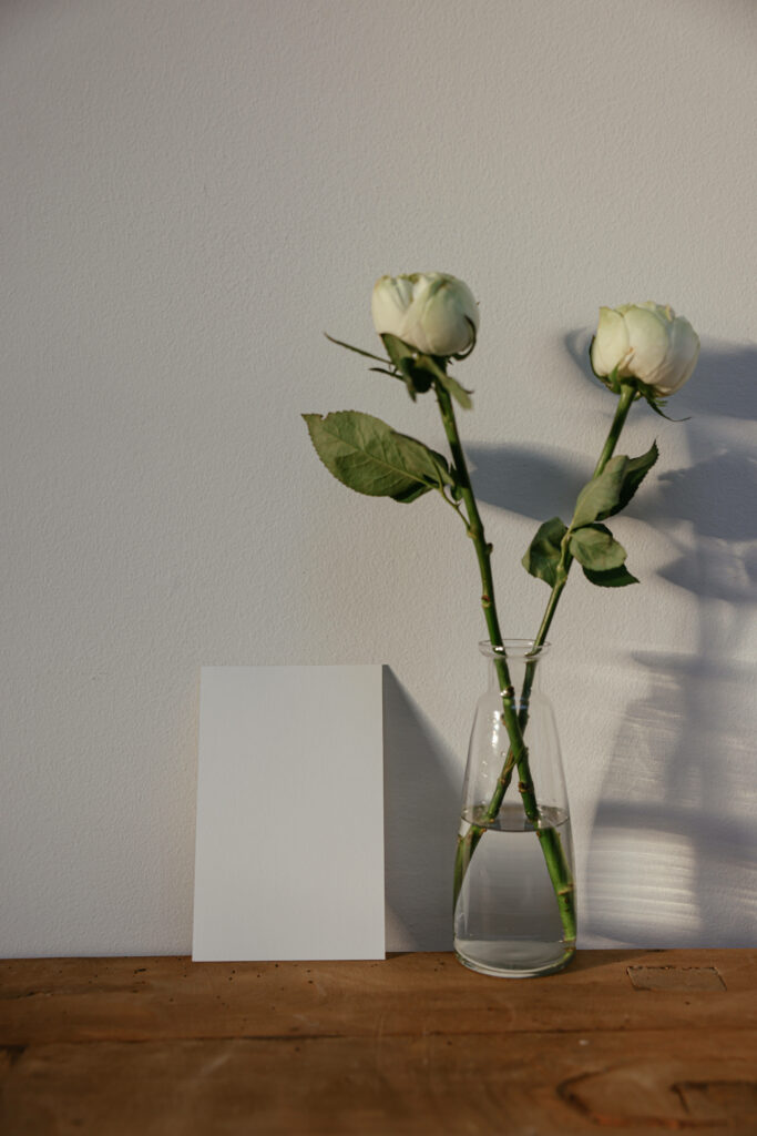 Elegant White Roses in Clear Vase - Minimalist Wallpaper Background
