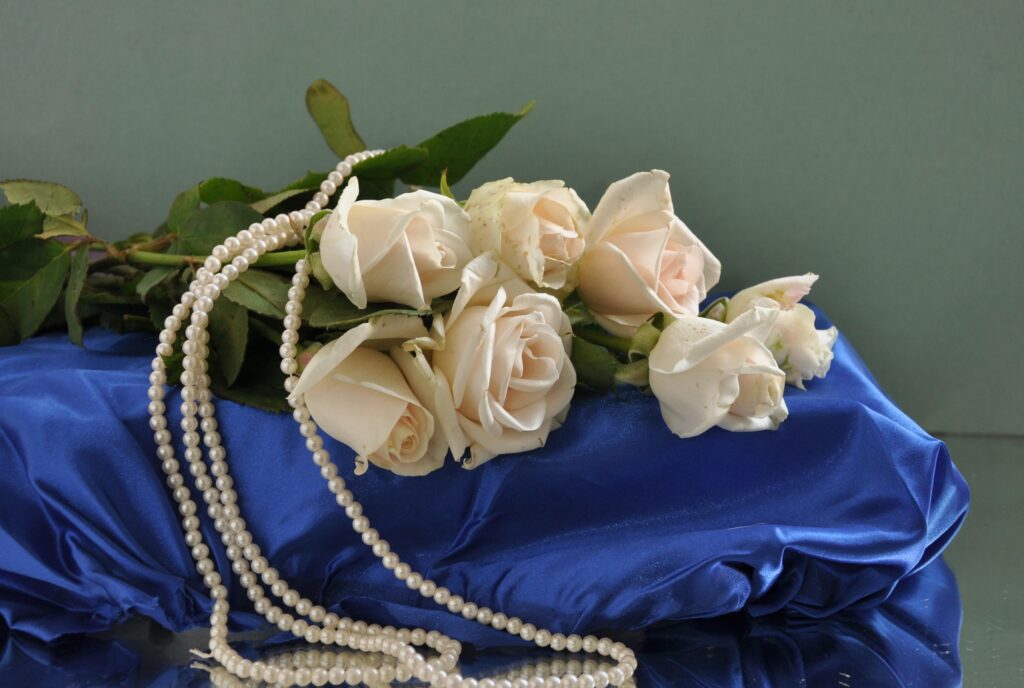 Elegant White Roses on Blue Satin with Pearls - Timeless Wallpaper