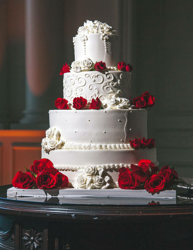 Elegant white wedding cake with red and white roses luxury classic celebratory wallpaper background