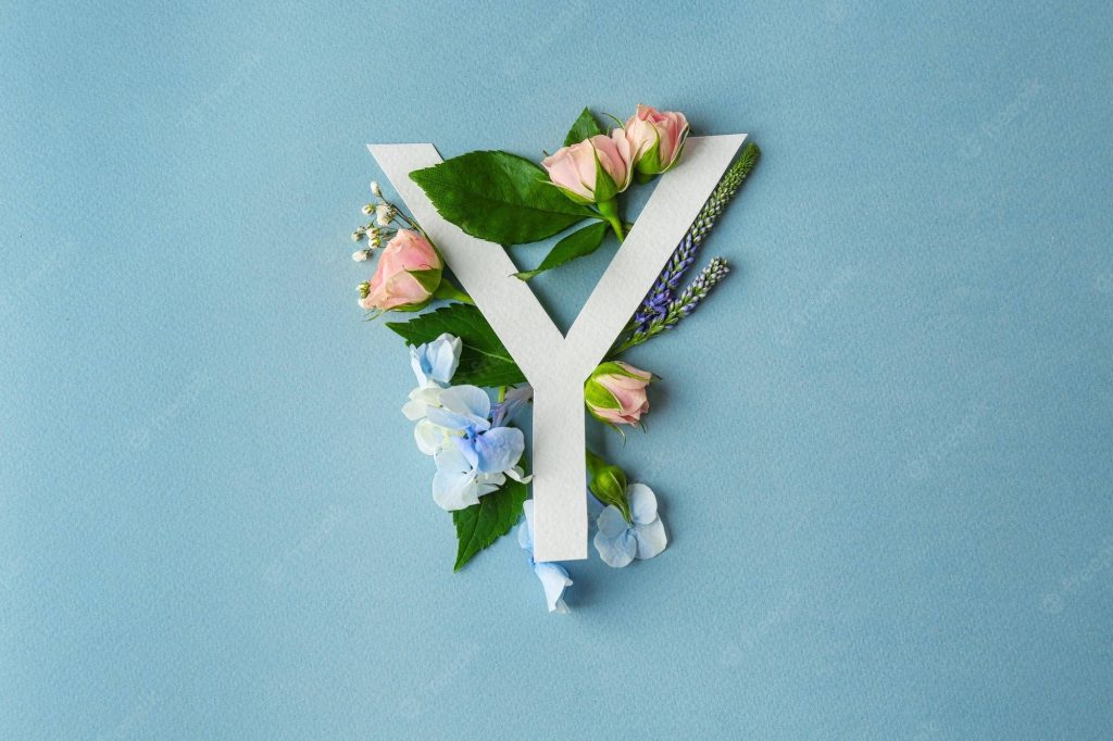 White letter Y wallpaper with pink roses blue hydrangeas green leaves on soft blue background