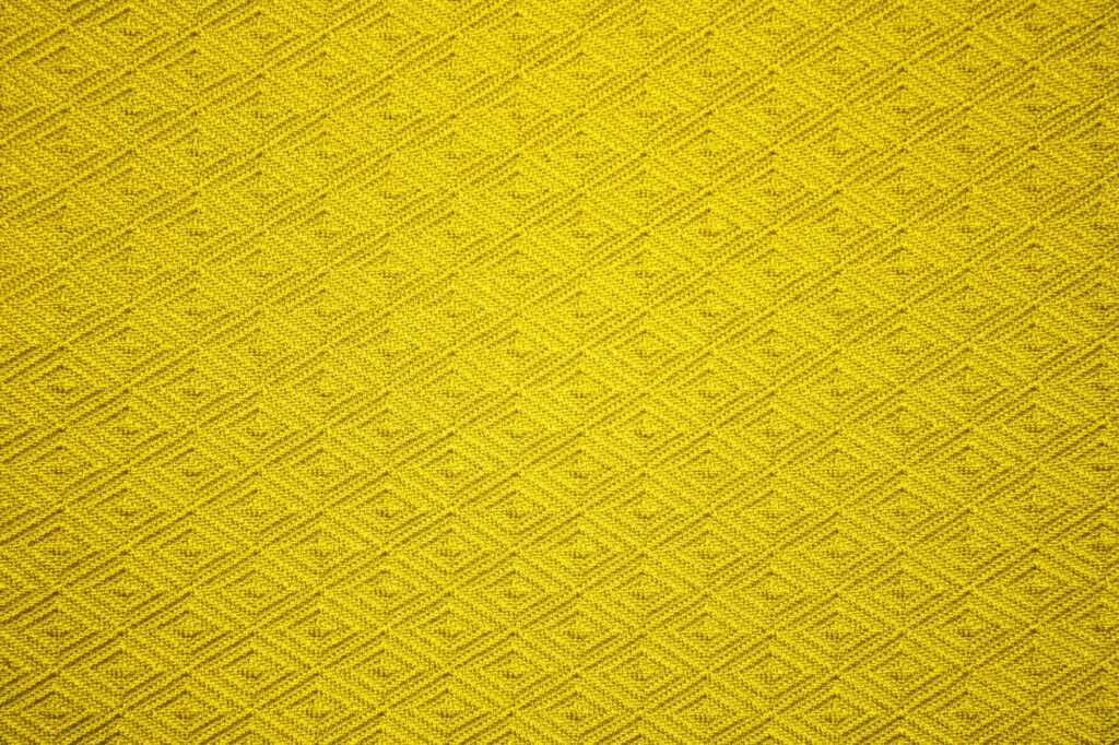 Vibrant Yellow Fabric Wallpaper with Elegant Diamond Pattern Design