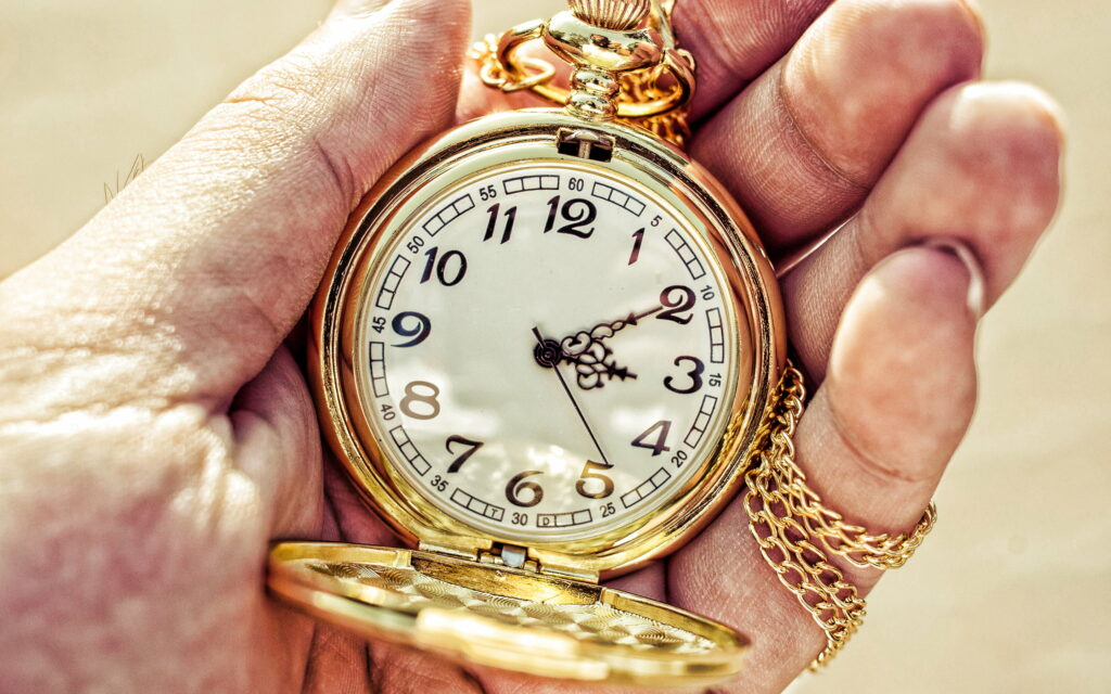 Glimpses of Time: Embracing the Golden Hourglass Wallpaper