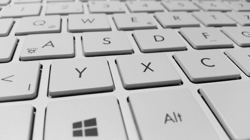 Laptop Companion: A Sleek White Keyboard Enhancing Your Computing Experience Wallpaper