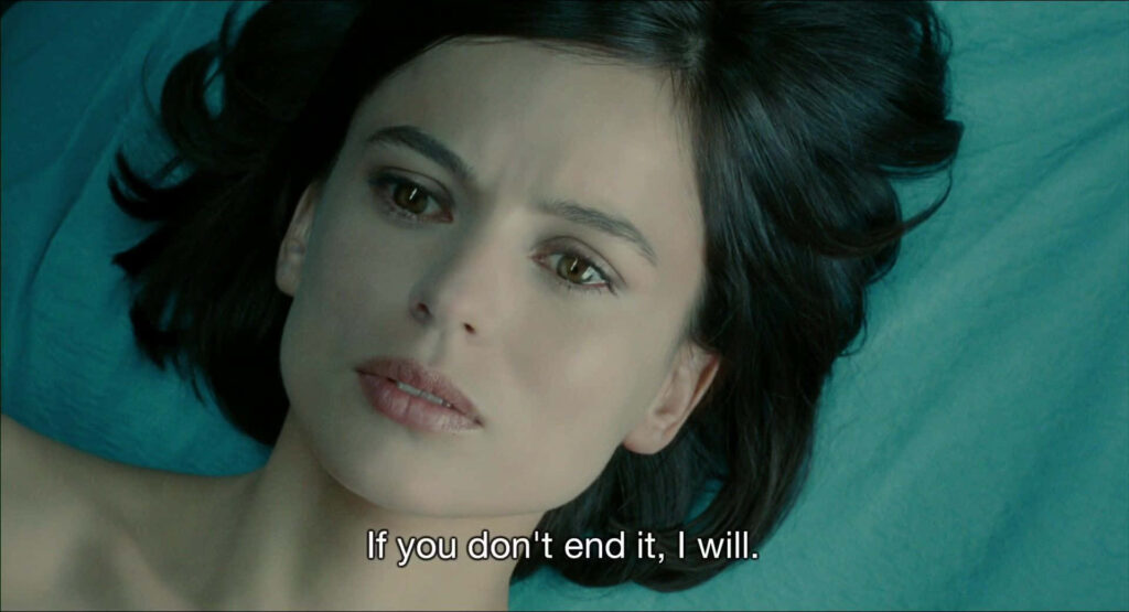 Elena Anaya against teal background intense gaze cinematic lighting serious mood wallpaper