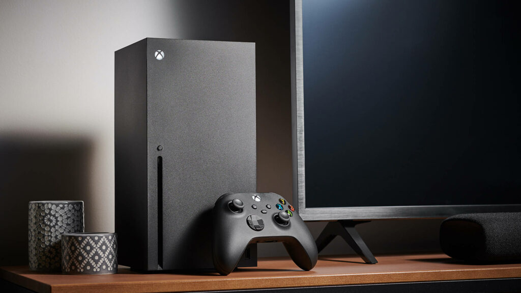 The Xbox Series X Showcase on a Stylish Wooden Table, Complemented by a Cozy Living Room Vibe Wallpaper