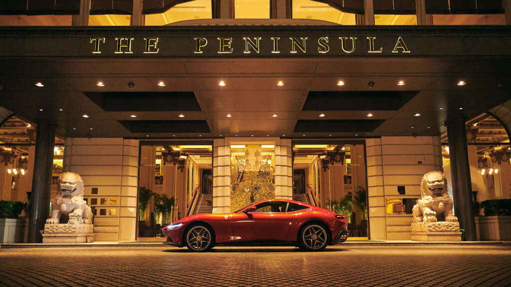 Unleashing Thrills: Embrace the Breathtaking Ferrari Roma Experience, Embodied in a Vibrant Red Beauty Against Majestic Skies Wallpaper