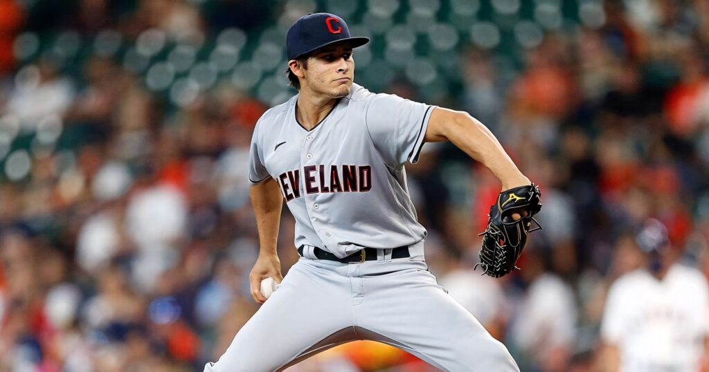Eli Morgan pitching in grey Cleveland Guardians uniform intense focus MLB stadium background wallpaper