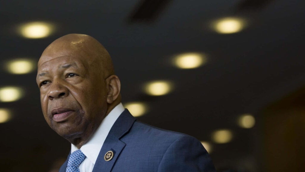 Elijah Cummings portrait wallpaper showing thoughtful political leader in blue suit with warm lights