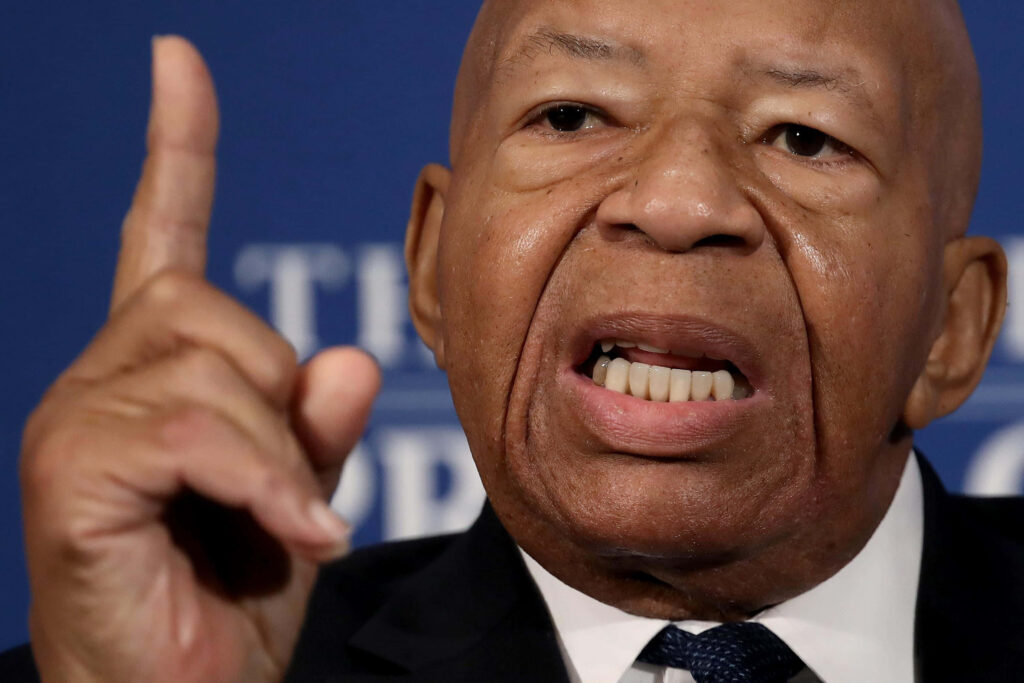 Elijah Cummings close-up wallpaper showing determined expression and leadership on blue background