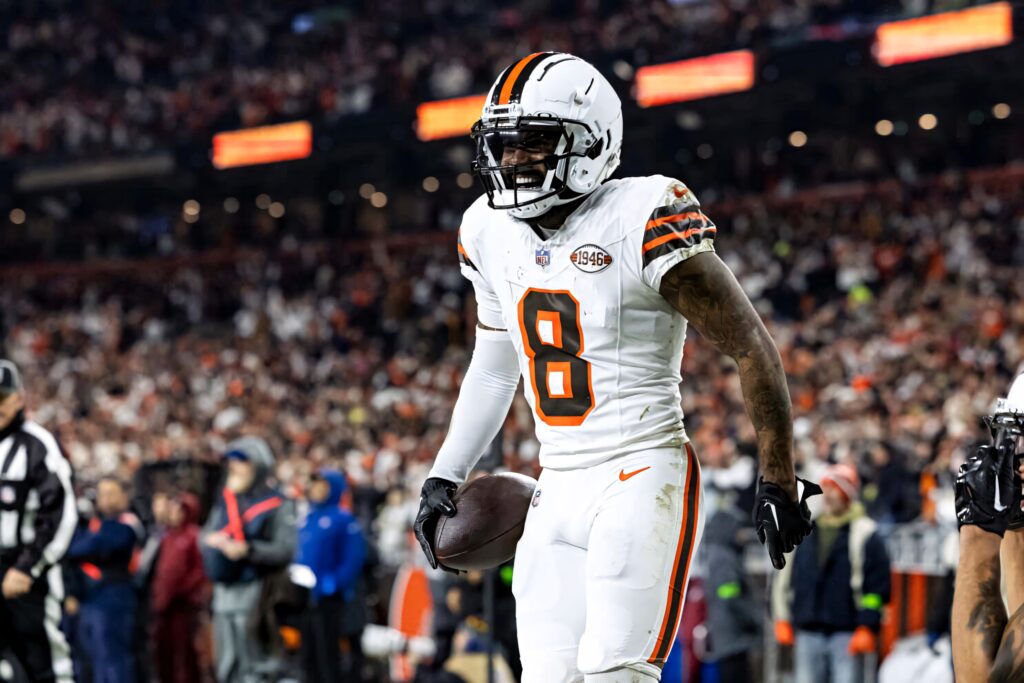 Elijah Moore in white and orange Cleveland Browns uniform focused during intense football game Wallpaper