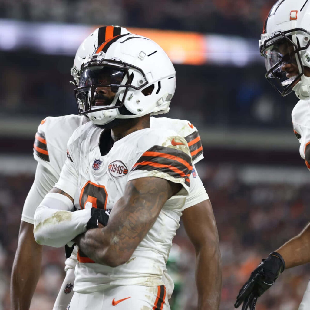Elijah Moore in Cleveland Browns uniform celebrating football victory under stadium lights Wallpaper
