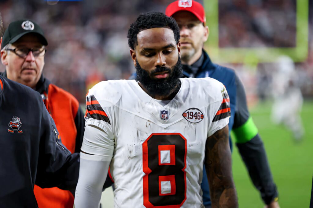 Elijah Moore number 8 walking off football field in Cleveland Browns uniform dynamic stadium lights Wallpaper