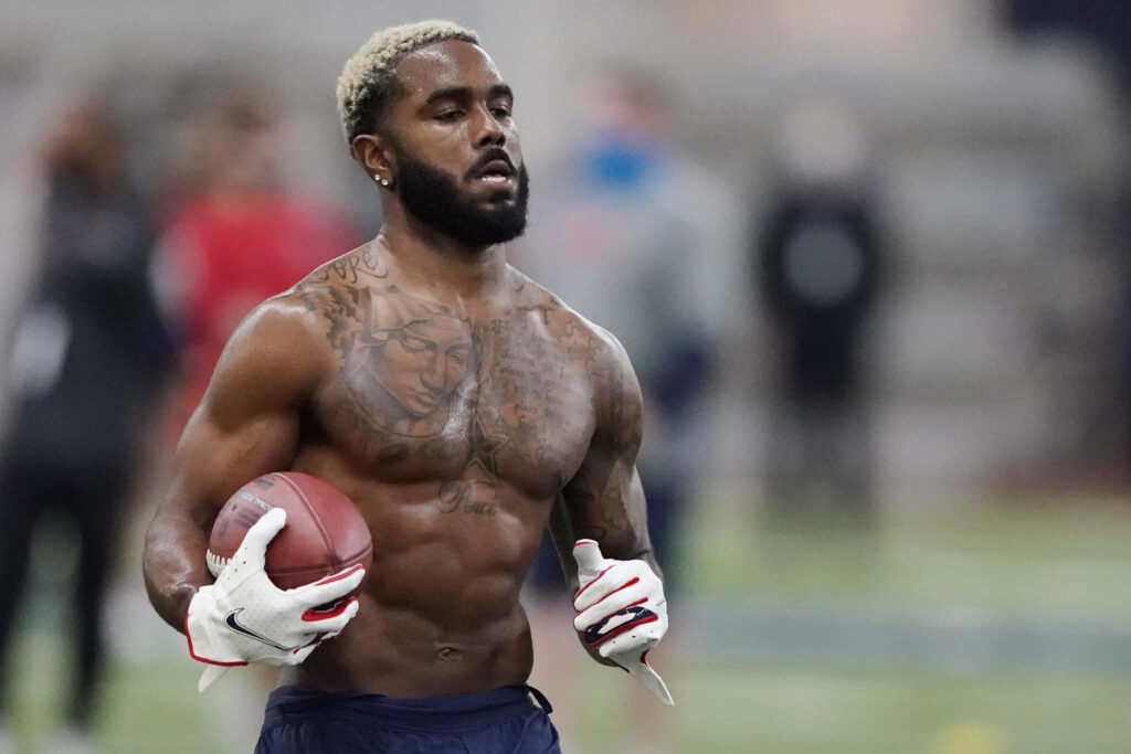 Elijah Moore shirtless football training showing athletic build tattoos strength and focus Wallpaper