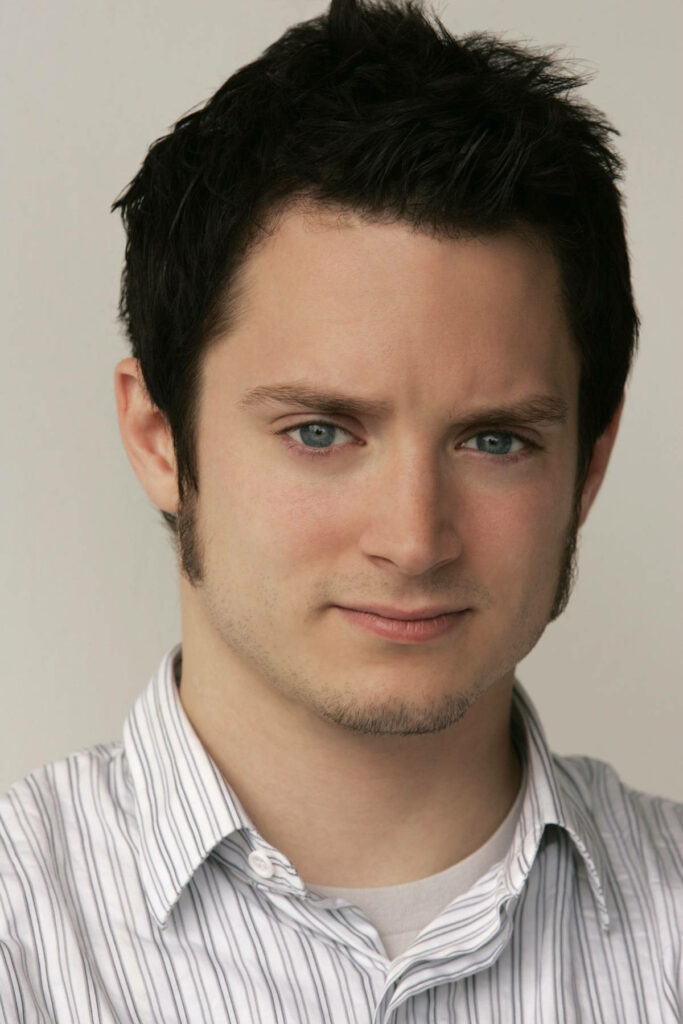 Elijah Wood studio portrait with striped shirt calm expression blue eyes neutral background wallpaper