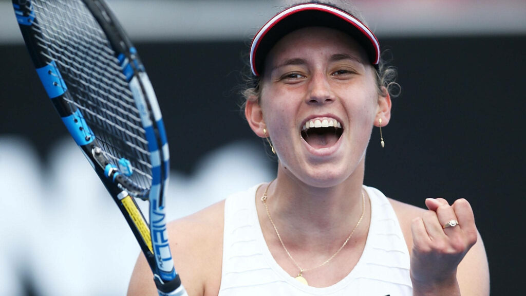 Elise Mertens celebrates tennis victory smiling in athletic wear holding racquet vibrant wallpaper