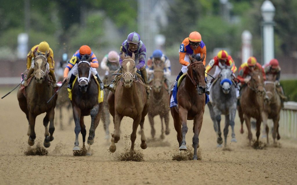 Elite horse racing action with jockeys in vibrant silks and thoroughbred Beholder sprinting fast Wallpaper