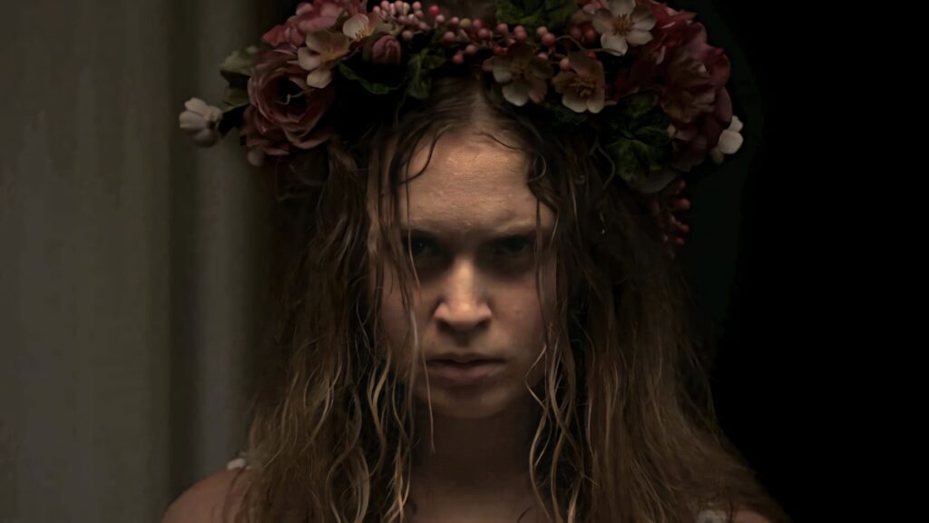 Eliza Scanlen as Amma Crellin in Sharp Objects intense gaze with wet hair and floral crown wallpaper