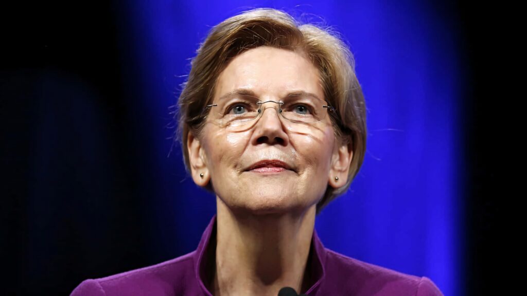 Elizabeth Warren in purple blazer and glasses looking confident against deep blue background wallpaper