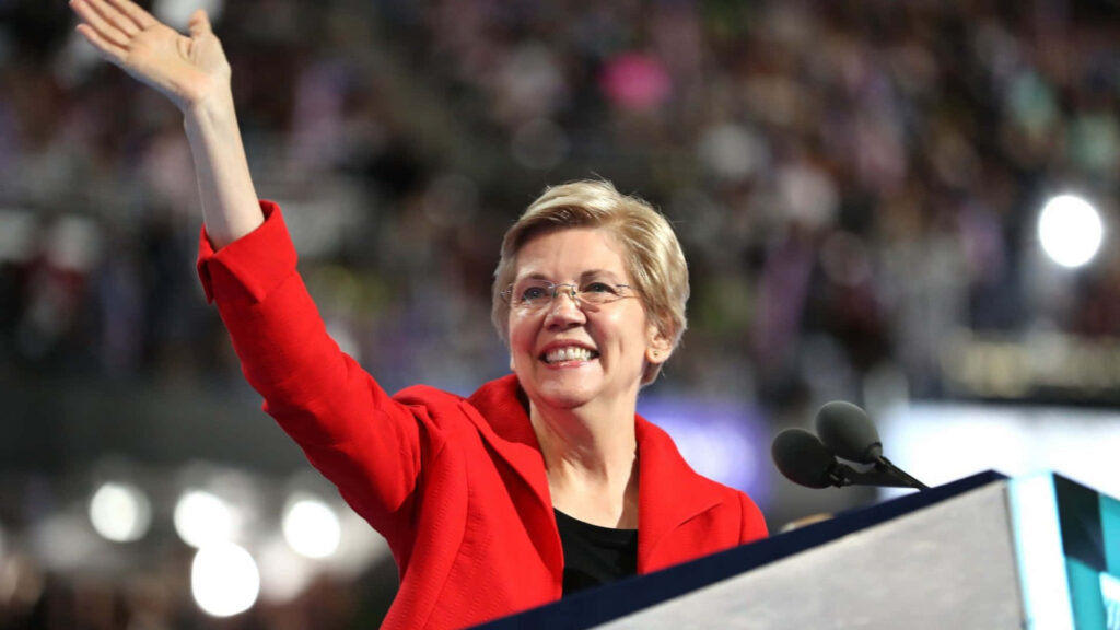 Elizabeth Warren in red blazer smiling and waving to crowd vibrant wallpaper background leadership