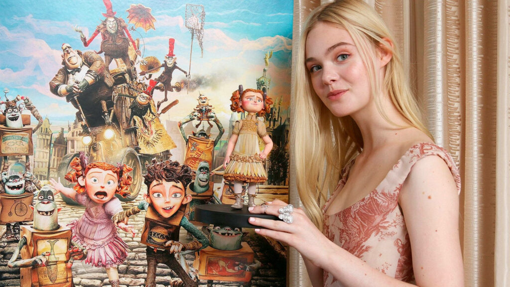 Elle Fanning with Winnie Figurine Against Colorful Boxtrolls Wallpaper